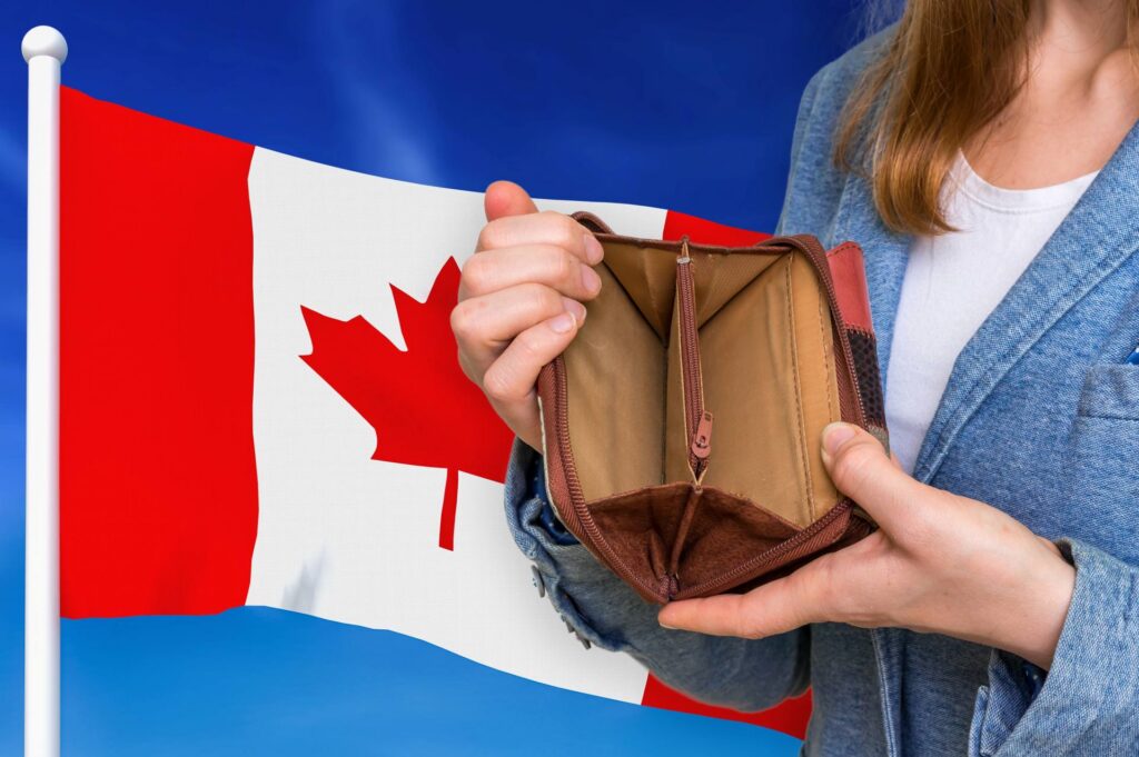 Canada flag behind person with wallet empty