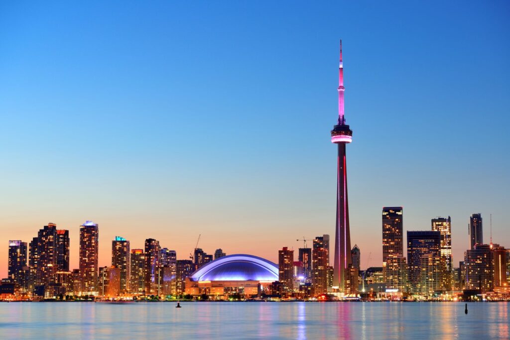 skyline view of Toronto at twilight hour, featuring CN tower in background prominently